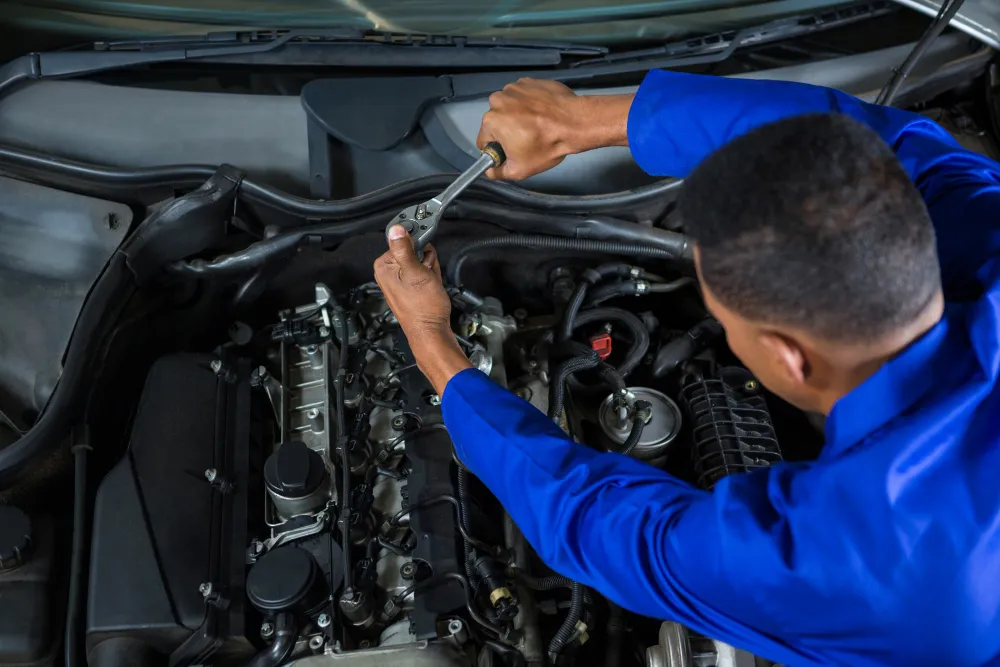 Technician servicing car air conditioning system in Dubai