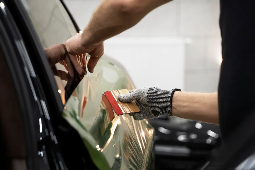 Professional vinyl car wrapping on a vehicle in Dubai