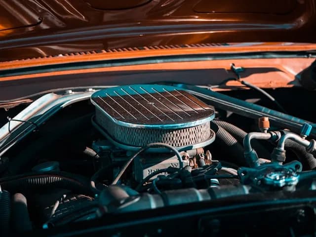 Technician inspecting car engine cooling system in Dubai