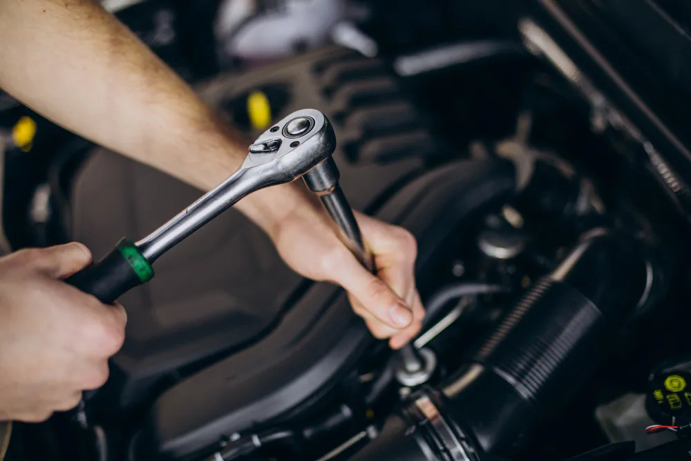 Technician performing car maintenance and repair in Dubai